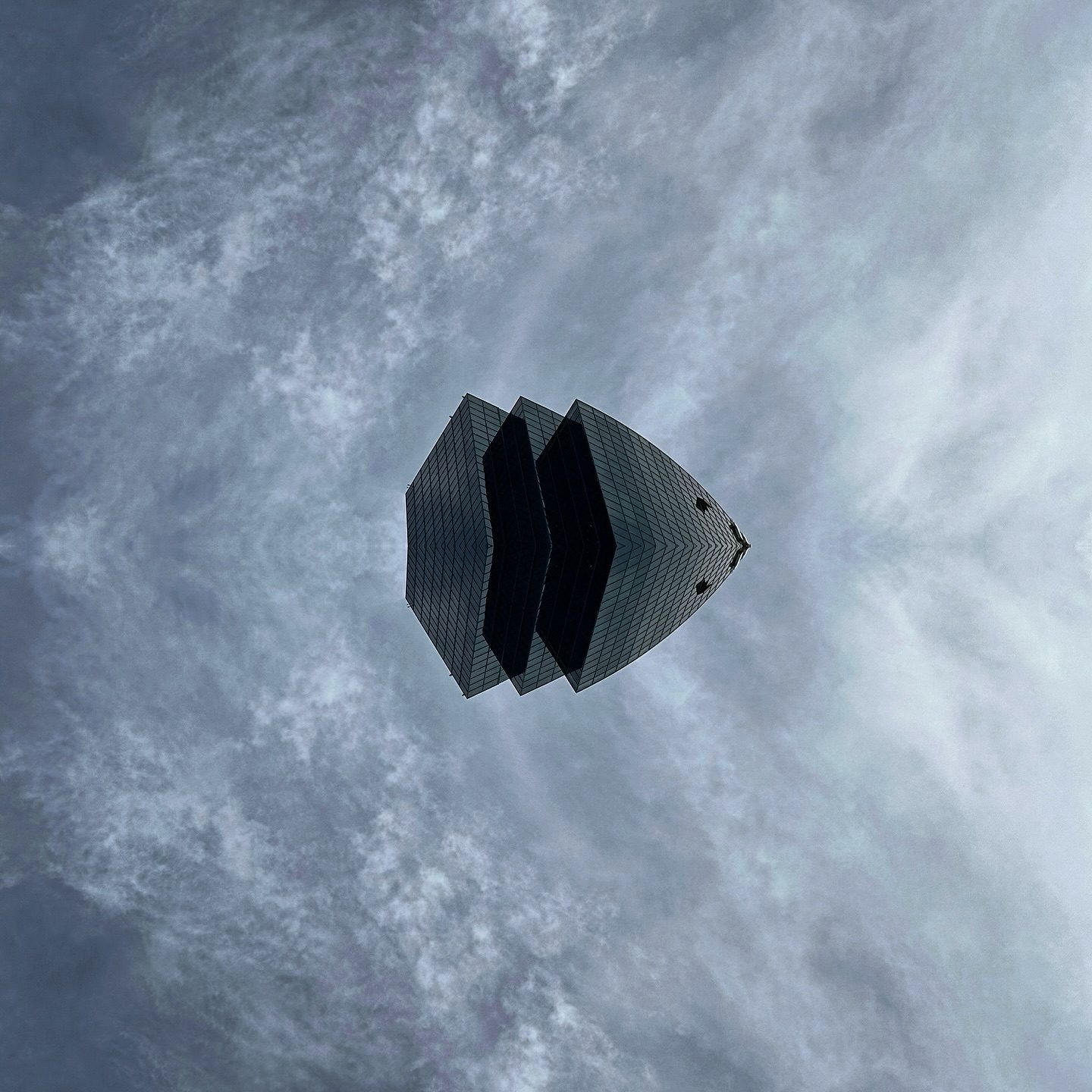 Abstract geometric structure against cloudy sky