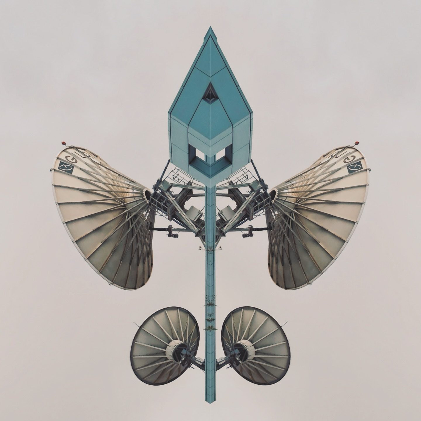 blue spire structure with four fan-like wings